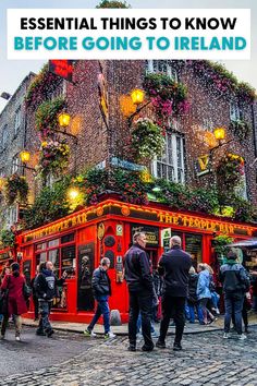 people walking around in front of a building with flowers growing on it and the words essential things to know before going to ireland