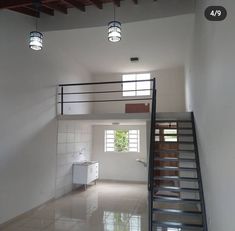 an empty room with stairs leading up to the second floor