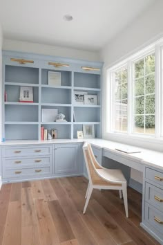 a chair sits in the middle of a room with built - in bookshelves