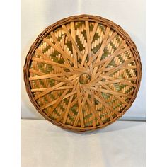 a wicker basket sitting on top of a white table