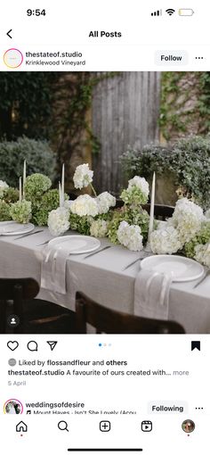 the table is set with white flowers and candles