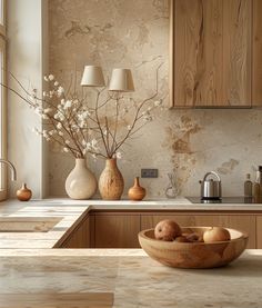 a wooden bowl filled with fruit sitting on top of a counter