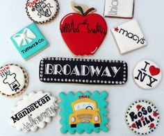 decorated cookies are arranged in the shape of an apple, bus, and name tags