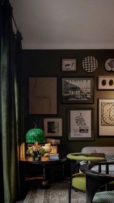 a living room filled with furniture and pictures on the wall