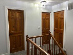 an empty room with wooden doors and stairs