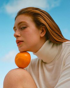 a woman with an orange on her neck