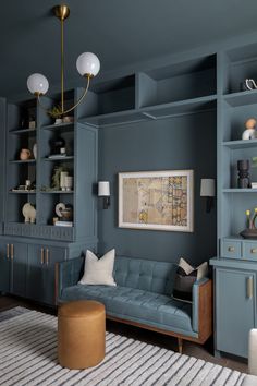 a living room with blue walls and shelves on the wall, a white rug in front of it