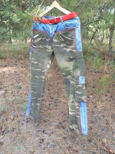 a pair of jeans hanging on a clothes line in the woods