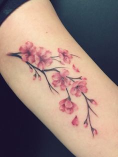 a woman's arm with pink flowers on it