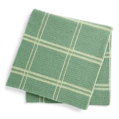 two green and white plaid napkins sitting on top of each other