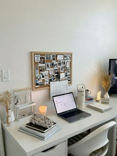 a white desk topped with a laptop computer