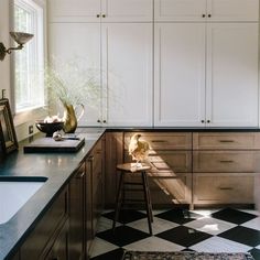 a kitchen with black and white checkered flooring