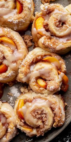 several pastries with peaches and powdered sugar on top