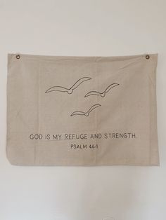 a banner hanging on the wall that says god is my refuge and strength with two seagulls