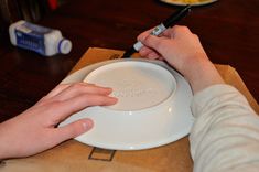 a person is using a marker to write on a plate