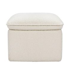 a white ottoman with a cushion on top