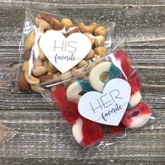 two bags filled with different types of candy and nuts on top of a wooden table