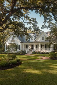 a large white house surrounded by trees and bushes