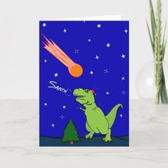 a greeting card featuring a cartoon dinosaur with an orange ball in the sky above it