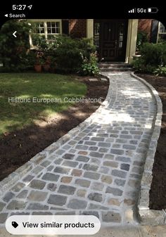 a brick walkway in front of a house