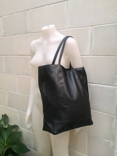 Large tote leather bag in BLACK. Leather shopper bag. Soft leather shoulder bag. Large enough for books or a laptop, tablet, cosmetics bag etc. Leather shopper. The inside of the bag is not lined (although properly finished!) . We added a small leather pouch on the inner part of the bag (4th pic) The bag can be closed by 2 leather straps attached to each side. Excellent quality soft but strong genuine leather. Width upper part: 41cm - 16 inch Height: 38 cm - 15 inch This bag in different colors Black Leather-handled Tote Laptop Bag, Black Leather-handled Laptop Tote Bag, Minimalist Black Tote Laptop Bag, Black Minimalist Laptop Bag For Everyday, Minimalist Black Laptop Bag For Everyday, Minimalist Black Laptop Bag, Black Leather Laptop Bag With Leather Handles, Black Leather-lined Laptop Bag For Daily Use, Black Leather Lined Laptop Bag For Daily Use