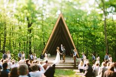 an outdoor wedding ceremony in the woods