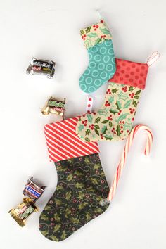 christmas stockings, candy and candies laid out on a white surface