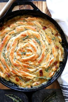 a skillet filled with cheese and onion rings