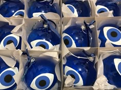 several blue and white evil eye ornaments in boxes