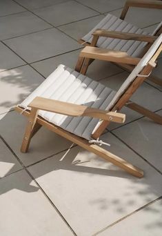 a wooden lawn chair sitting on top of a tile floor