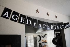 a black and white sign that says aged to perfection on the front of a mirror