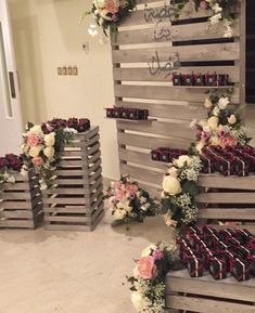 some wooden crates with flowers and candles on them