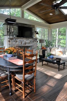 a dining room table and chairs in front of a fireplace