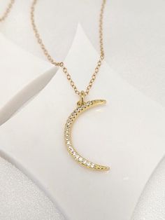 Our gift to you 10% off your first purchase. Details here - http:/eepurl.com/dpVPBzOur 1" crescent moon is set with dainty CZ stones for added sparkle. So pretty alone or layered!Dangles from our signature sparkly gold fill chain.....................DETAILS14 k fill chain and components18 k gold fill moonCubic zirconia stones.This listing is for one moon necklace onlyMoon is approximately 1" longNorah Stella Jewelry is made with the highest quality components.All jewelry comes wrapped and ready Gold Necklace With Moon Charm And Cubic Zirconia, Gold Necklace With Moon Charm In Cubic Zirconia, Simple Choker Necklace, Moon Necklace Gold, Tiny Pearl Necklace, Dainty Necklace Layered, Dainty Choker Necklace, Wishbone Necklace, Single Pearl Necklace