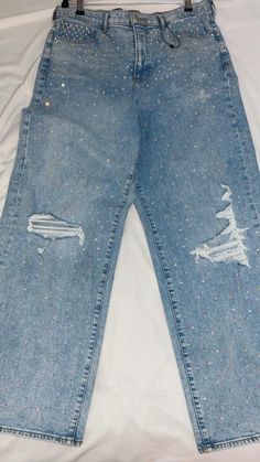 This is an EXPRESS Brand Jean, Size 14r that features slightly relaxed fit and wide legs. 5 pocket design.  Jeans have been hand pressed in a  delicately blinged with AB rhinestones for a unique design and fleur de lis add ons.  Light wash Small Stretch Ripped design Trendy Straight Leg Jeans With Rhinestones, Trendy Straight Leg Pants With Rhinestones, Casual High Rise Jeans With Rhinestones, Casual High-rise Rhinestone Jeans, Blue Rhinestone Straight Leg Jeans, Casual Medium Wash Rhinestones Bottoms, Diy Rhinestone Jeans, Bling Pants, Jeans With Rhinestones