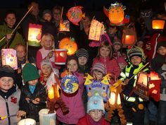 a group of children holding up paper lanterns