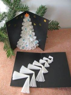 an origami christmas tree is on the table