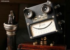 an old fashioned radio sitting on top of a wooden box next to a metal pipe