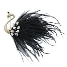 a brooch with black feathers and crystal stones in the shape of a swan, on a white background