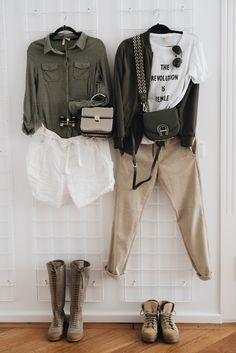 clothes hanging on the wall with shoes and purses next to each other in front of them