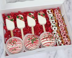 a box filled with assorted candy covered lollipops