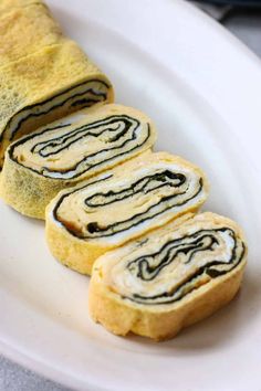 japanese rolled egg with nori tamagoyaki on a white plate and text overlay