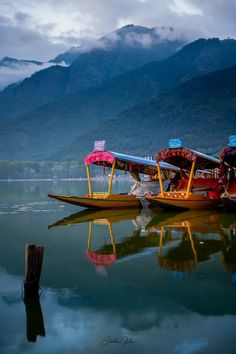 two boats on the water with mountains in the background