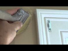 a person using a brush to clean a door