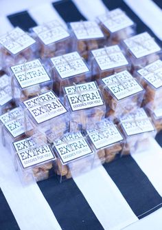 several boxes of extra extra soap sitting on top of a black and white striped tablecloth