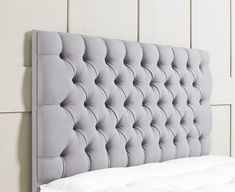 an upholstered headboard for a bed with buttons on the top and bottom