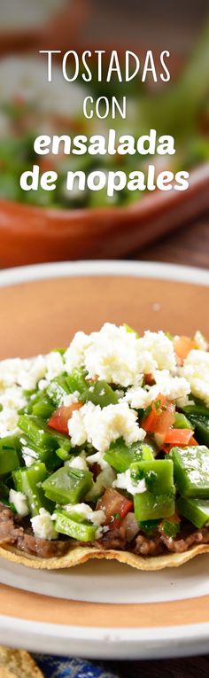 a plate with some food on it and the words tostadas con ensalada de nopales