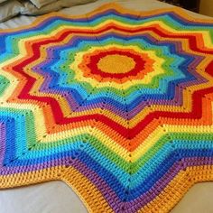 a crocheted blanket on top of a bed