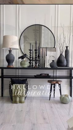 there are many vases and lamps on the table in front of the mirror, along with other decorative items