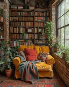 a yellow couch sitting in front of a window filled with lots of books and plants